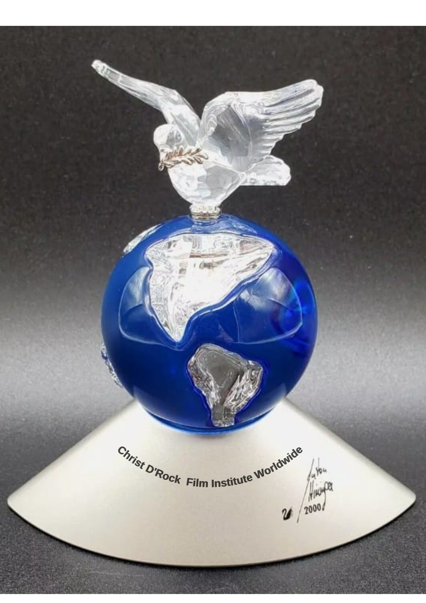 Dove standing on a blue glass globe, representing worldwide peace and faith